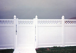 White fence with lattice and post caps